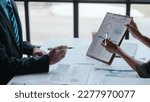 Small photo of Auditor and the company's bookkeeper jointly review the balance sheet and assets, liabilities and equity information in the quarterly report, bookkeeping concept.