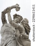 Small photo of Warsaw, Poland - Royal Lazienki - 02.05.2023: BACCHANTE HOLDING A CLUSTER OF GRAPES. A section of the Gods sculpture in a Greek-style park. A man is playfully interacting with a woman.