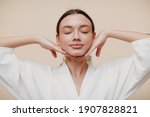 Small photo of Young woman doing face building yoga facial gymnastics self massage and rejuvenating exercises