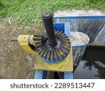 Small photo of The "Old Style Irrigation Sluice" portion of the irrigation sluice that is less maintained is blue and yellow.