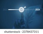 Businessman Hand touching on download bar status to change from 2023 to 2024 in change and start new and happy new year by technology concept, Start new business and new life

