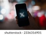 Small photo of Man hand holding Phone with social networking service x logo on the screen, Twitter will officially rebrand as X later today, Elon Musk confirms. Qatar, July 23, 2023