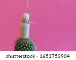 The concept of unbearable pain. Pain leads to suicide.Figurine of a man on needles with a noose around his neck on a pink background. copy space