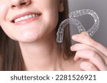 Aligners for straightening teeth in a woman's hand