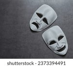 Small photo of theatre theater theatrical tragedy drama comedy mask on grey background. theatre theater theatrical tragedy drama comedy mask. white happy and sad theatre theater theatrical tragedy drama comedy mask