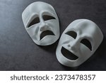 Small photo of theatre theater theatrical tragedy drama comedy mask on grey background. theatre theater theatrical tragedy drama comedy mask. white happy and sad theatre theater theatrical tragedy drama comedy mask