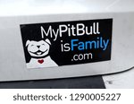 Small photo of ST PAUL, MINNESOTA / USA - APRIL 18, 2016: Euphemistic bumper sticker trying to send the message that Pitbull dogs could be friendly or family.
