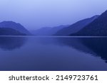 Small photo of Lake Teletskoye, Altai Republic, Siberia, Russia. Blue clear sky and Mirror of lake. Abstract panoramic landscape, nature environment scene, minimal monochrome background with tonal perspective