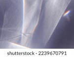 Small photo of Sunlight background, abstract photo with light and shadow, glare and shine on paper texture, rainbow flare from sun, gray blue monochrome minimal aesthetic fon. Natural light and caustic effects.