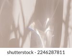Small photo of Sunlight background, abstract photo with light and shadow, glare and shine on paper texture, rainbow flare, beige monochrome minimal scene. Natural light and caustic effects, trend aesthetic fon.
