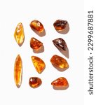 Small photo of Set of Natural gemstone amber stones with glare shadows, yellow orange colored isolated on white background. Natural mineral Transparent amber gems different forms, flat lay pattern, minimal top view