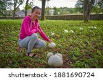 Woman Among Large Puffballs In...