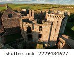 Old Medieval castle in UK. Scenic landscapes, historic buildings, and beautiful sculptures in England. The ruins of Medieval castle in United Kingdom. Raglan Castle, Monmouthshire, Wales, UK. 