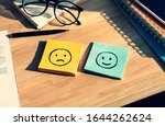 Emotional of human on work life concepts with happy and fail emotion on notepaper.Mental health