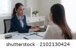 Small photo of Asia real estate sale agent, stock market trader woman work at bank office talk in tax plan report. Lawyer help ask or advice lease on laptop desk typing fund loan data. Smile happy trust in HR job.