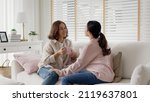 Small photo of Young senior citizen authentic real family sit talk to grown up children kid with love share moment at home living room feeling positive relax enjoy listen to child girl. Parent coach communication.