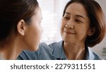 Small photo of Middle aged asia people old mom love care trust comfort help young teen talk crying stress relief at home. Mum as friend listen adult child woman feel pain sad worry of broken heart life crisis issues