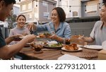 Small photo of Mom enjoy thai meal cooking for family day home dining at dine table cozy patio. Mum passing serving food to group four asia people young adult man woman friend fun joy relax warm night picnic eating.