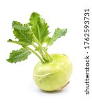Small photo of Fresh kohlrabi with green leaves on isolated white background.
