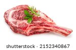 Small photo of Fresh Tomahawk beef steak isolated on white background, Tomahawk beef steak on white background With clipping path.
