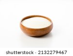 Small photo of Skim milk powder in Wooden round bowl on white background