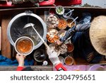 top view thai asian old woman  Making noodles on the boat  in the local floating market in the central Thai tradition  very famous  causing many tourists to come and see each other