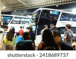 Small photo of Bangkok-Thailand, November 18, 2023: Large crowd of people waiting to get on a bus in Mo Chit or Morchit Bus Terminal station transit hub center, a transportation hub to northern and east-north region