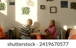 Small photo of Couple in cafe. An elderly man engages in effective communication through nonviolent communication, combining verbal and nonverbal cues, converses articulately, using gestures to enhance expression.