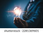 Idea innovation and inspiration concept. Hand of man holding illuminated light bulb, concept creativity with bulbs that shine glitter. Inspiration of ideas for sustainable business development.network