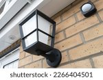 Newly installed multi-colour outdoor smart light seen together with a wireless PIR detector.