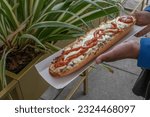 Small photo of experience the taste of poland with a mouthwatering zapiekanka, a hot sandwich on a half baguette, generously filled with various toppings, offering a satisfying and flavorful street food option