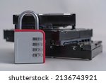 Small photo of Encrypted hard disk. Padlock with cipher on an opened hard disk. Data loss. computer motherboard. the concept of data, hardware, information technology and cyber security.