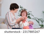 Small photo of elderly sisters enjoying their golden years in a cherished pastime of knitting together. Lifelong Learning. ongoing engagement in knitting suggests commitment to lifelong learning