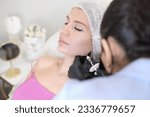 Small photo of With syringe in hand, beauty doctor is shown performing injection into the patient's jowls, part of effective treatment sculpt facial contour. patient lying during non-surgical face lift procedure