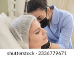 Small photo of cosmetology clinic, where skilled aesthetician is seen injecting filler into jowls. procedure, focusing on reducing masseter lines and enhancing face shape