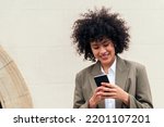 woman smiles happy sending message with her phone