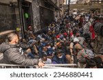 Small photo of After the barriers were placed, dozens of migrants were seen sitting shoulder to shoulder on the sidewalk waiting for their chance to enter Roosevelt Hotel. Manhattan, New York, August 01, 2023.