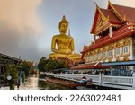 Big Buddha (Wat Paknam) at sunset. Chao Phraya river canal cruise. Tourists traveling by traditional boats. Thailand's most important travel destinations. Bangkok, Thailand
