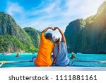 Happy couple traveler doing heart shape joy relaxing on boat Maya beach, Krabi Phuket, Travel adventure nature Thailand, Tourist beautiful destination place Asia, Summer holiday outdoor vacation trip