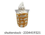 Vanilla soft serve ice cream with caramel syrup in a clear plastic cup isolated on white background with clipping path and copy space. Frozen yogurt vanilla caramel sundae cold dessert.