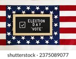Small photo of Happy Election Day letter board with Vote check mark against American flag background. Don't forget to VOTE on USA election day. Template for US elections.