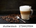 glass of latte macchiato coffee on a dark background