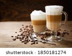 glasses of latte macchiato coffee on a wooden background