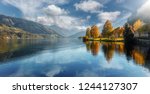 Beautiful Sunny day in Alps. wonderlust view of highland lake With autumn trees under sunlight and perfect sky. Landscape with Alps and Zeller See in Zell am See, Salzburger Land, Austria