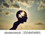 Small photo of Concept of a human head with a puzzle in the middle. Finding a solution in the human brain. Concept of cognitive rehabilitation in Alzheimer's disease and dementia patien. Mental health.
