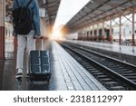 man backpacker traveler plan safety trip low cost budget summer holiday after coronavirus. Empty tourist on train railway platform. Use bus train sustainable environmental friendly transport..