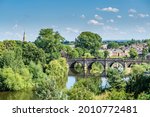 View towards the English bridge, Shrewsbury, Shropshire on a hot summer day with luscious vegetation.