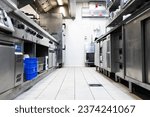 Small photo of Corridor of a restaurant kitchen with all its metal cabinets on the sides