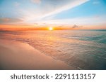 Closeup of sand on beach and blue summer sky. Panoramic beach landscape. Empty tropical beach and seascape. Orange and golden sunset sky, soft sand, calmness, tranquil relaxing sunlight, summer mood