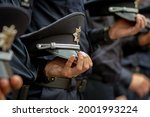 Small photo of Uniform cap in the hand of Ukrainian policemen